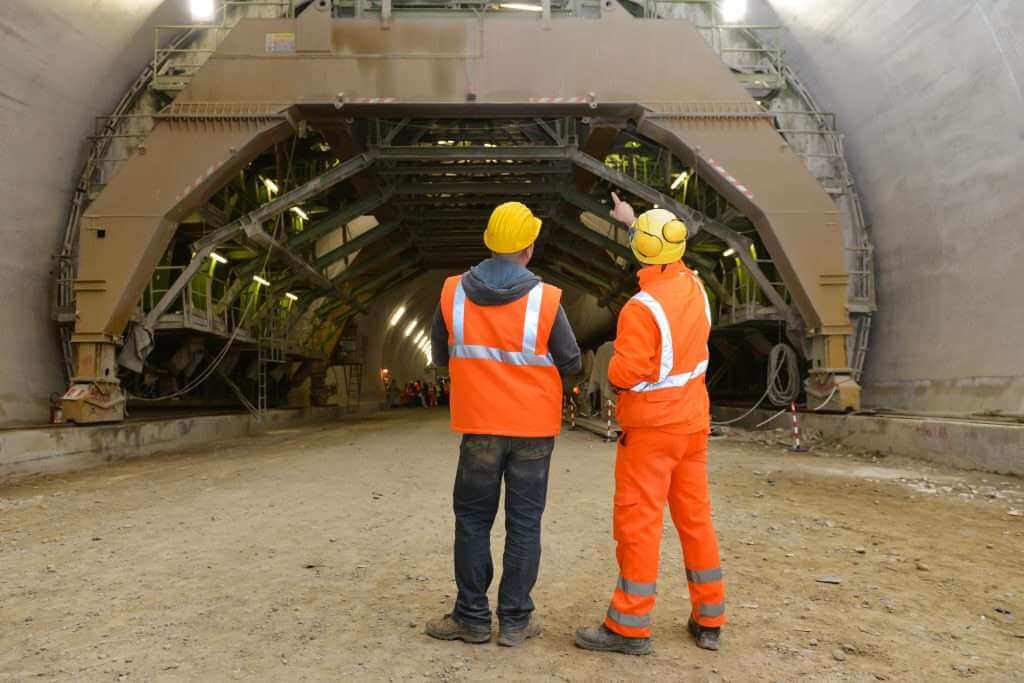 worker outside tunnel inspecting