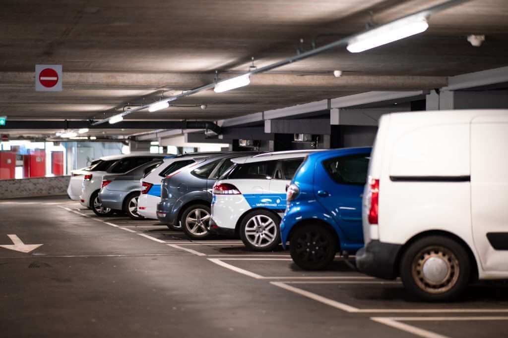 cars parked in parking lot underground with light